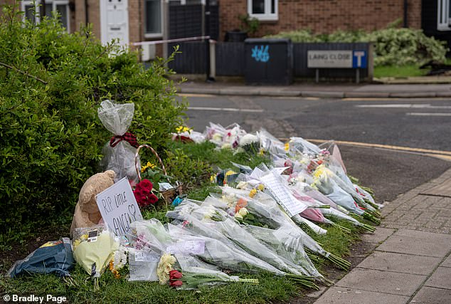 Tributes included a teddy bear and a sign that said 'RIP Little Angel' with a love heart.