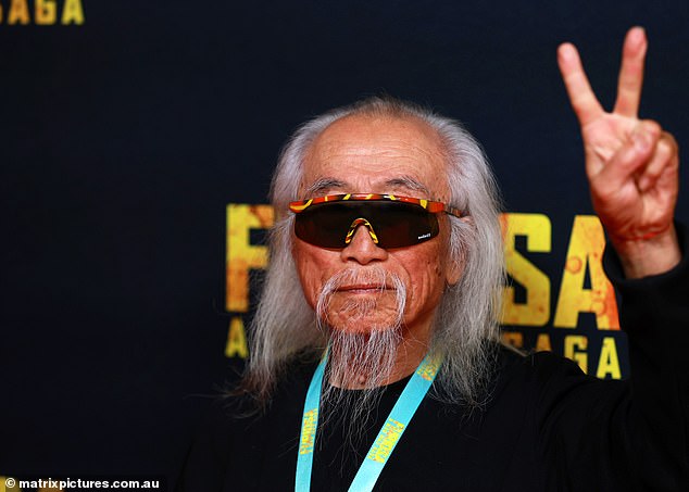 In a rare appearance without his iconic signs, Danny flashed the peace sign while posing on the star-studded red carpet.