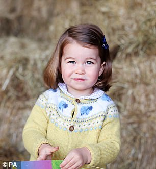 For her second birthday portrait, Charlotte donned a sweet yellow cardigan.