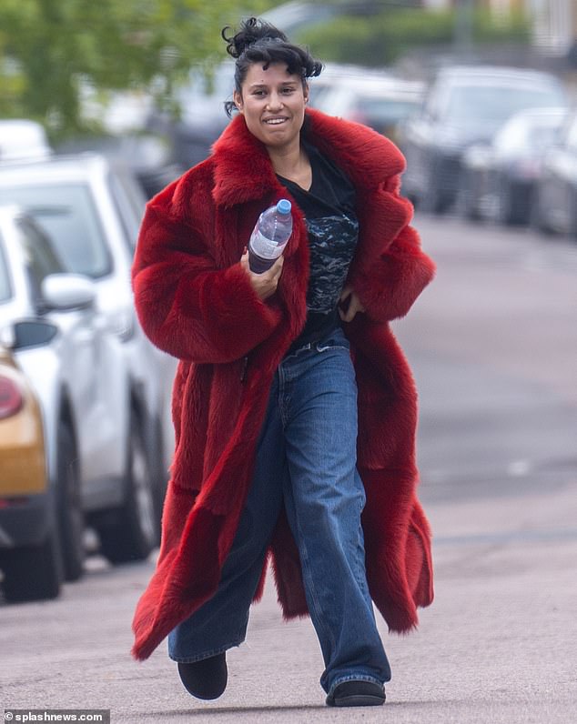 The award-winning singer looked fabulous in an exaggerated red faux fur coat with silk lining and oversized lapels.