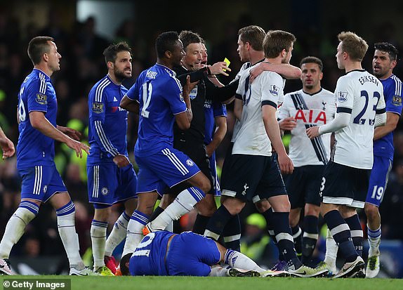 LONDON, ENGLAND - MAY 2: Referee Mark Clattenburg is caught in the melee as Eden Hazard of Chelsea lies injured during the Barclays Premier League match between Chelsea and Tottenham Hotspur at Stamford Bridge on May 2, 2016 in London, England.  (Photo by Catherine Ivill - AMA/Getty Images)