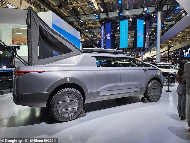 The model on display this week at the 2024 Beijing Auto Show featured a pop-up tent on a mattress in the bed of its truck, protected by a heavier but more rounded silver metal body, as well as a full-length rear LED. complete that transmits messages to those who pass by.  motorists