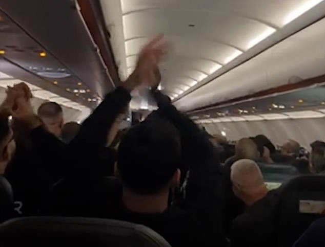 Customers dissatisfied with the scale began to cheer before most of the booth burst into chants of 'cheerio!'  and began applauding the officers who escorted the couple off the flight.