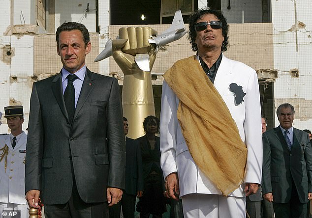 Libyan leader Moammar Gaddafi (right) and then-French President Nicolas Sarkozy during the national anthems at the Bab Azizia Palace in Tripoli on July 25, 2007.