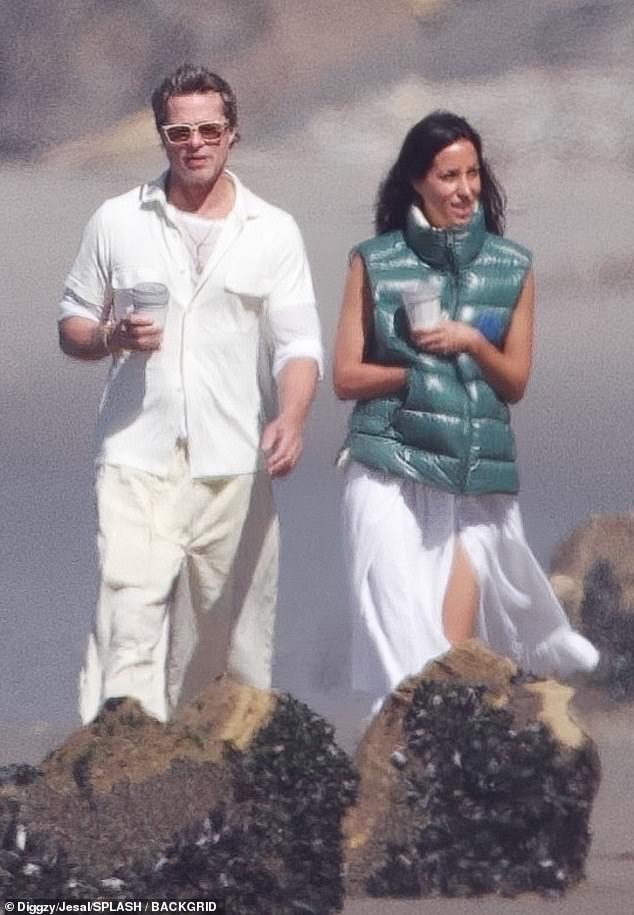The Fight Club alum looked youthful in an all-white outfit.  He was wearing a cream colored shirt with the sleeves rolled up and a t-shirt underneath.  Paired with his blouse, he wore wide-leg khaki pants and matching sneakers for their morning walk.