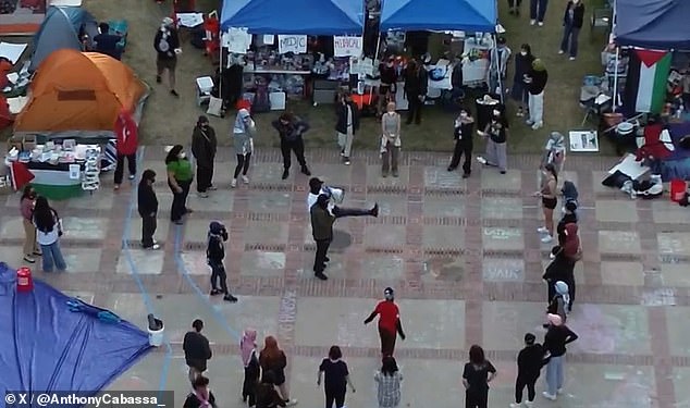Drone footage taken just before a nighttime clash on Wednesday shows students learning hand-to-hand combat techniques taught by a balaclava-wearing protester.