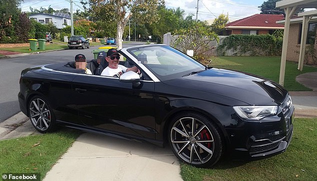 The former police officer is seen posing in his black Audi convertible on November 20