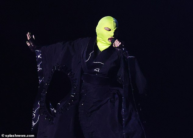 The pop superstar was photographed during a rehearsal session on Tuesday wearing a neon green balaclava.