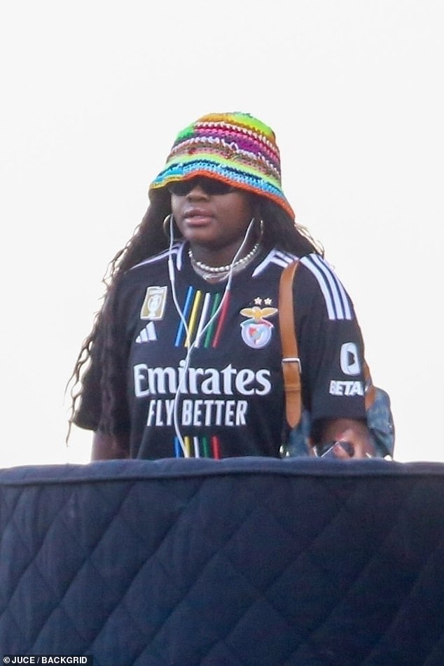 Madonna's daughter Mercy James donned a black Emirates soccer jersey at the hotel, complete with a knitted rainbow bucket hat.