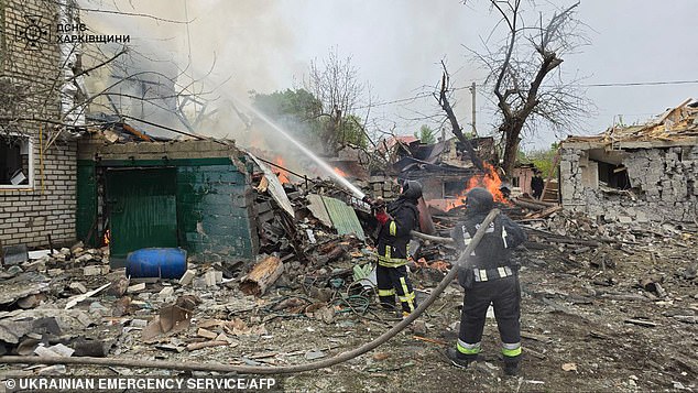 Firefighters fighting a house fire after Russian attacks, in the city of Derhachi, Kharkiv region, amid the Russian invasion of Ukraine on April 26.