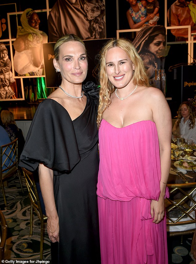 Rumer was also seen posing at the event with Molly Sims, dressed in an off-the-shoulder black dress with her blonde hair tied back.