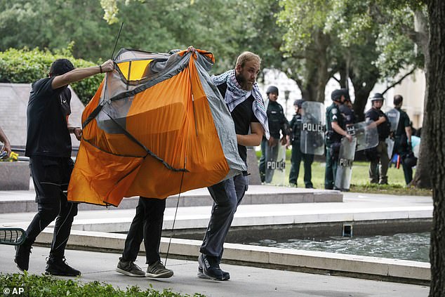 Pro-Palestinian protesters take their belongings and leave the premises, while law enforcement patrols the University of South Florida.
