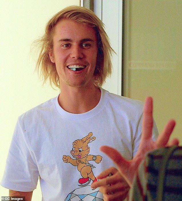 In this July 2018 snapshot taken in New York City, Bieber was photographed with long hair, but again had signs of a receding hairline on the sides of his scalp.