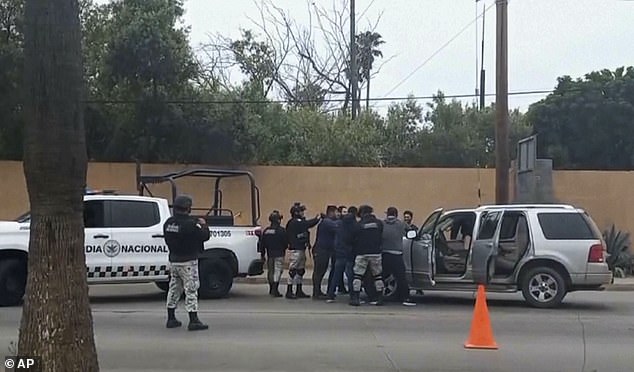 Three people have been arrested in connection with the investigation.  Mexican officials are seen at a checkpoint in Ensenada on Thursday.