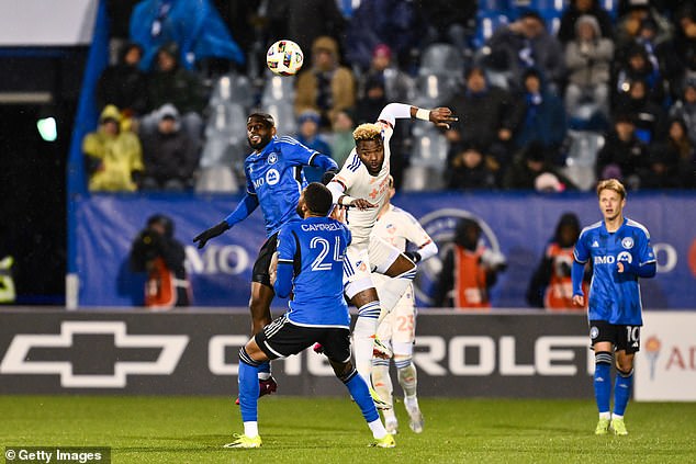 Boupendza (wearing white) is seen jumping for the ball against CF Montreal in a match last month.