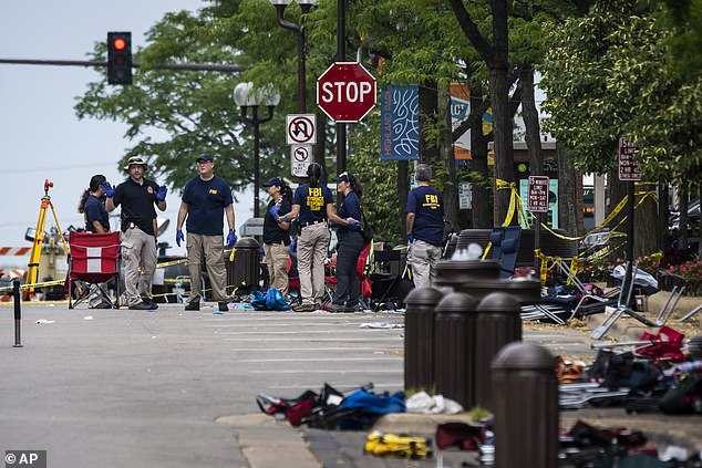 Members of the FBI's Evidence Response Team Unit investigate in downtown Highland Park, Illinois, on July 5, 2022, the day after a deadly mass shooting at a Fourth of July parade.