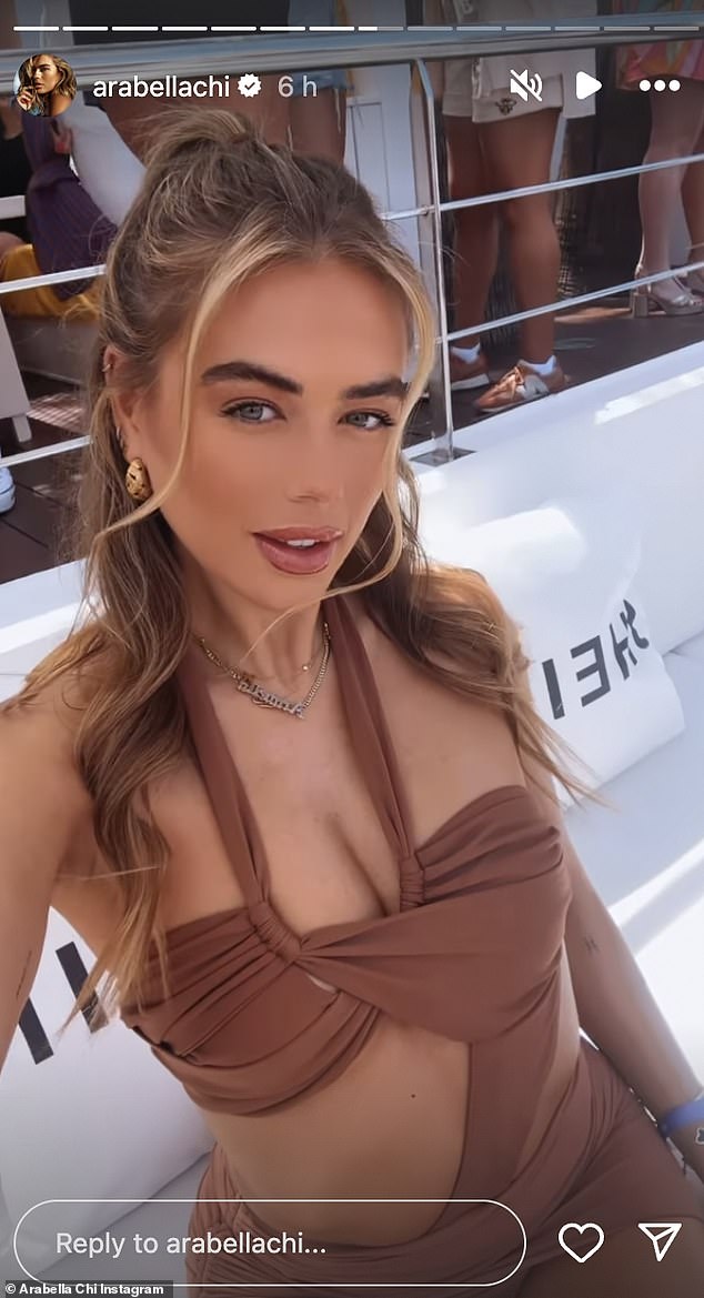 The TV personality, 33, showed off her endless legs in a skimpy brown minidress that featured a halter neck and cutout details at the bust, flaunting her flat stomach.