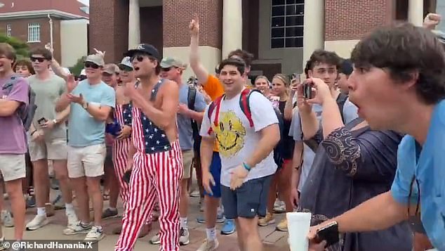 Counterprotesters, predominantly white and male, insulted the woman during Thursday's confrontation, including this student in blue on the right who made monkey gestures.