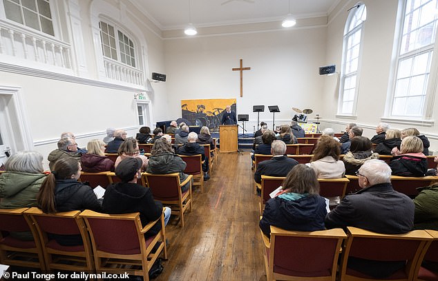 Members of the congregation gather during the Friday service, which Kate and Gerry McCann did not attend.