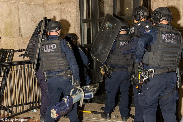 Members of the NYPD surround and storm Hamilton Hall, where protesters barricaded themselves on the campus of Columbia University on April 30, 2024 in New York City.