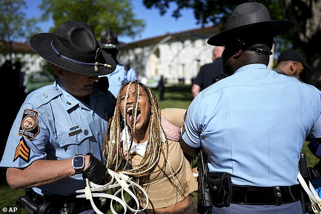 Georgia State Patrol officers detain a protester on the Emory University campus during a pro-Palestinian demonstration, Thursday, April 25, 2024.