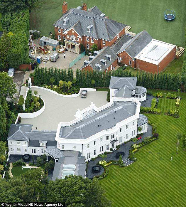 The footballer sold his former home (below) for £16 million in January 2014. He had planned to move into the property with his family, after building it next to his original home in Oxshott (above), which he sold in 2013.
