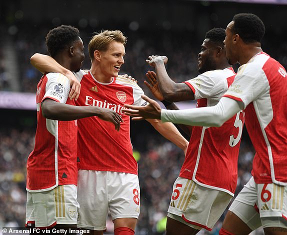 LONDON, ENGLAND - APRIL 28: (L-R) Bukayo Saka, Martin Odegaard, Thomas Partey and Gabriel celebrate Arsenal's first goal during the Premier League match between Tottenham Hotspur and Arsenal FC at the Tottenham Hotspur Stadium on April 28, 2024 in London, England.  (Photo by Stuart MacFarlane/Arsenal FC via Getty Images)