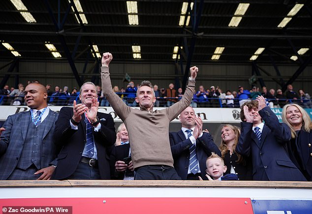 McKenna celebrates with the Ipswich Town directors his team's return to the top of English football.