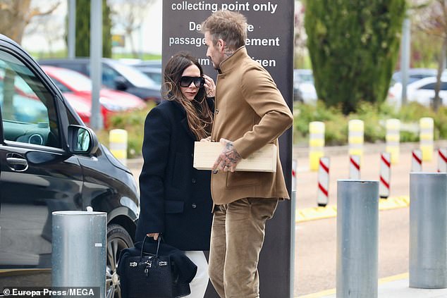 The pair were seen getting out of the car at the airport while Victoria hid behind her glasses.