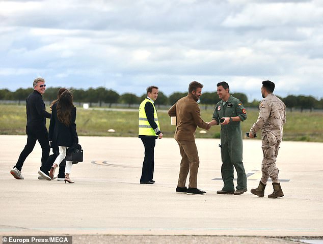 The others were seen laughing as they walked towards the plane.
