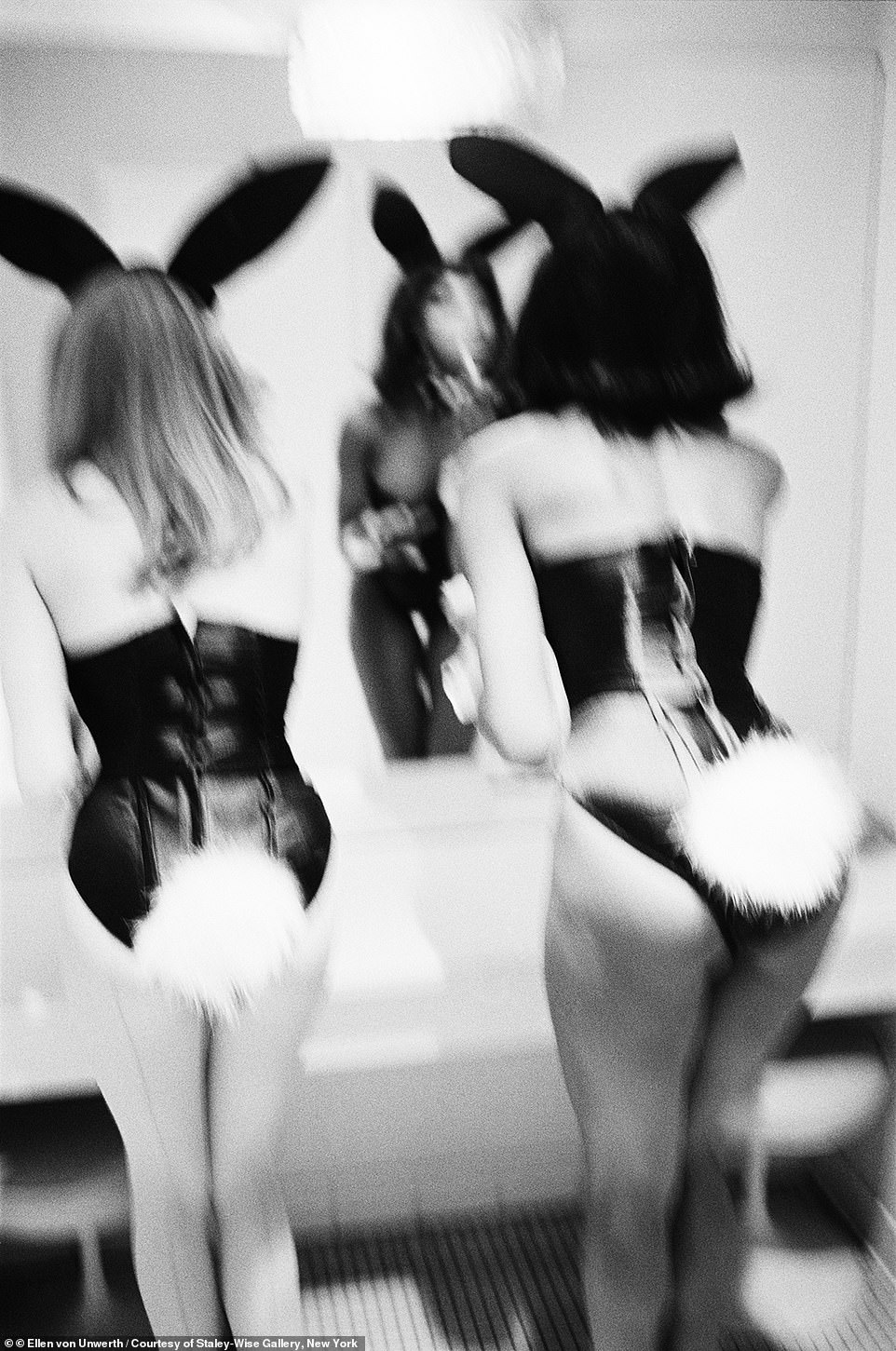 And in one image two Playboy bunnies are seen looking in a mirror and putting on makeup, with their butts front and center.