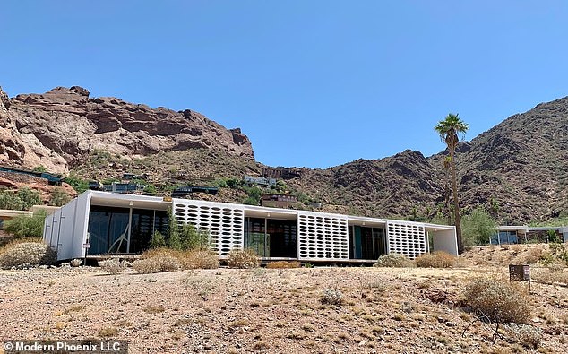 The 1954 house was built as a showcase for the modernity of the era, and its white exterior contrasts with the red rocks of Camelback behind it.