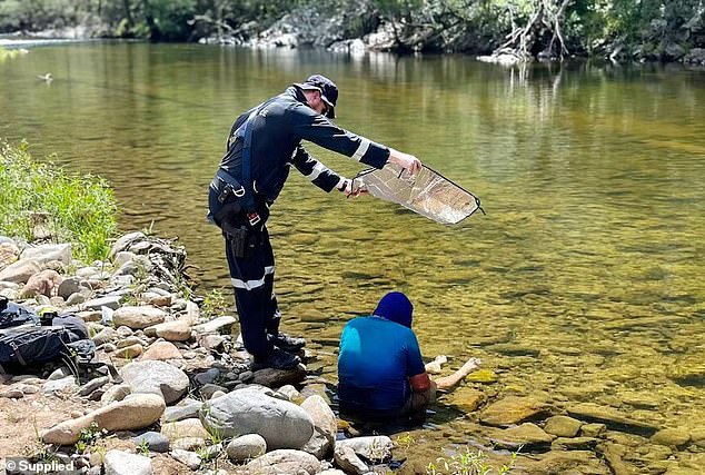 His rescuers found Mr Collins lying in the river trying to cool off with a towel to protect his skin from the strong sun (pictured).