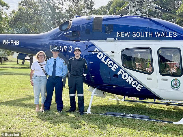 But in a delightful twist, the pilot who rescued him was present and had a photo taken with Mr Collins' wife, Melissa, and son, Ben (pictured).