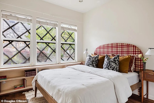 The first bedroom showcases the bold criss-cross window design from the interior point of view and fits perfectly above a fitted bookshelf and next to a cozy bed with tartan headboard.