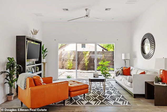 Inside the house, beds with shiny floors spread across the floor and white walls and furniture are found in the many rooms of the house.