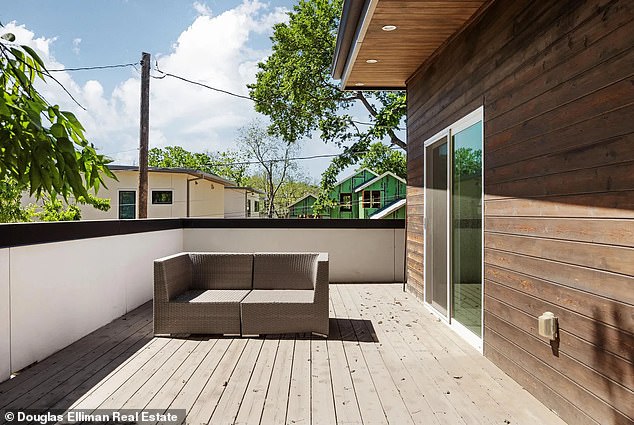 A spacious balcony can be accessed through one of the upstairs areas offering panoramic views of the charming Austin neighborhood.