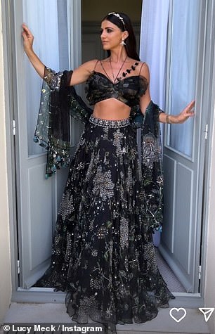 She looked amazing in a black printed crop top and matching full skirt as she posed for photos.