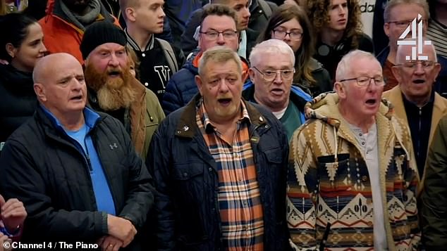 Her angelic voice was soon joined by passersby at the station, who turned out to be a male chorus.