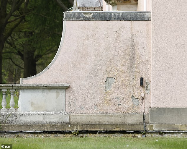 The exterior of the building is covered in peeling paint and needs to be sanded and repainted.