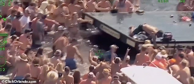 Several men throw punches back and forth in the fight (pictured), with at least a couple of fighters dragging each other from the top of the DJ booth into the lake.