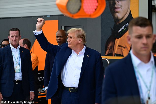 Trump gestured to his supporters in the crowd as he prepared to watch the race begin.