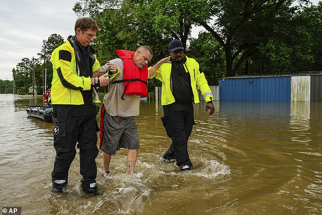 A man is rescued by the Community Fire Department in New Caney, Texas, on Friday