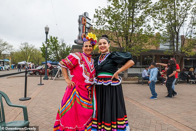 Women were seen dressed in long, sparkly layered dresses and with large flowers in their hair in Greely, Colorado.