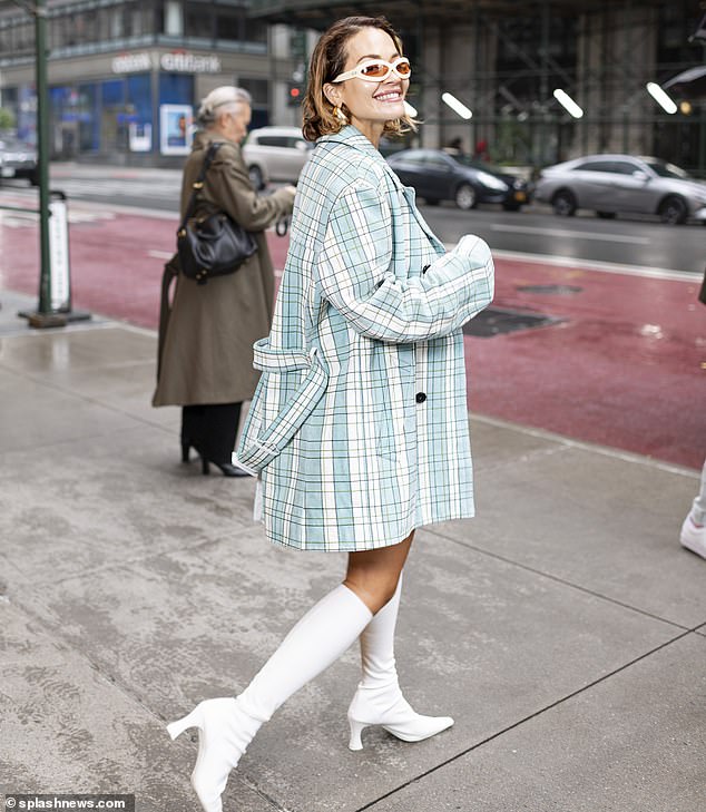 Rita smiled as she turned around in the belted coat with slightly overlong sleeves and showed off her big gold earrings.