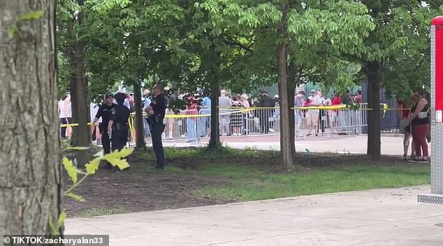 Police can be seen standing inside an area that was closed to the public.