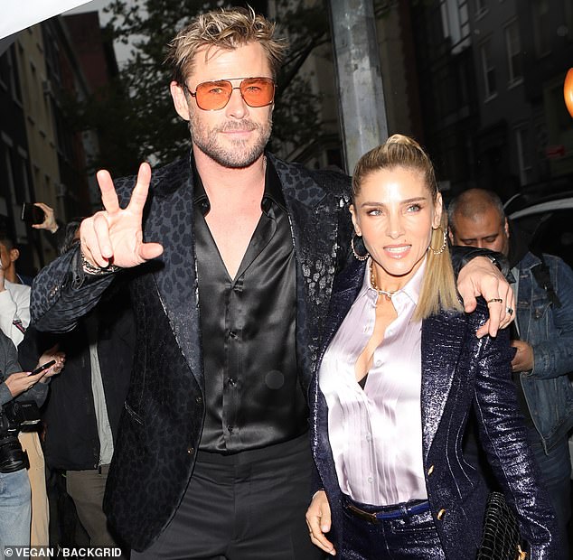 Chris sported a navy blue leopard-print suit with buttons undone to reveal his sculpted chest paired with retro orange sunglasses, while Elsa wore a blue sequined jacket and matching shorts.