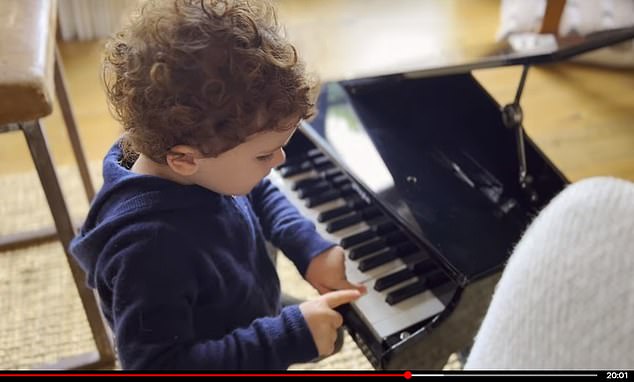 Archie plays with a toy grand piano in an image revealed in Harry and Meghan's Netflix documentary