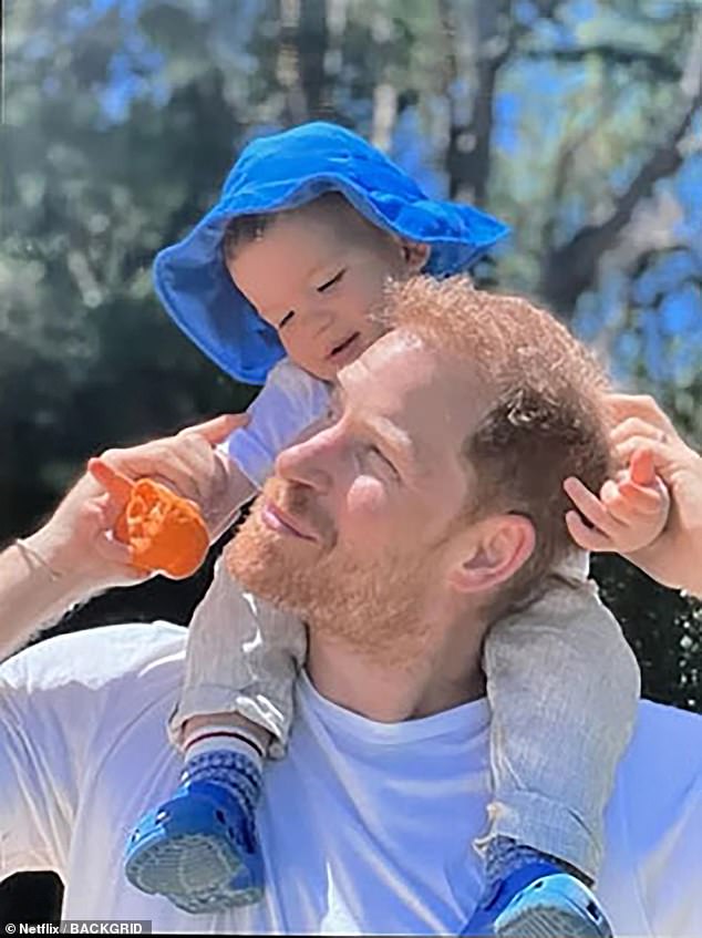 Archie is seen sitting on his father's shoulders in an image that was revealed in Harry and Meghan's Netflix documentary.