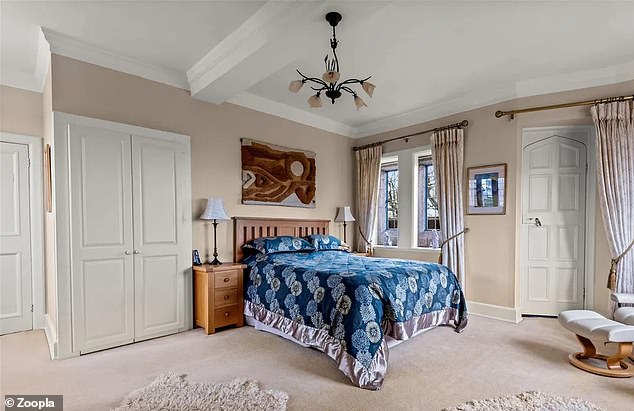 The attic has three bedrooms, including this one with period stone mullioned windows.